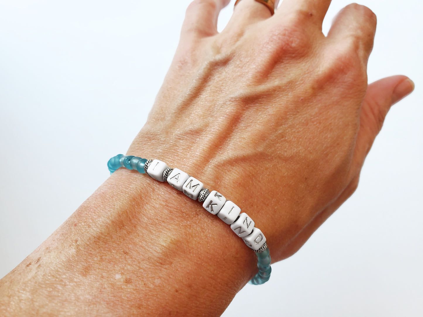 Aqua and silver single strand stackable Word bracelet