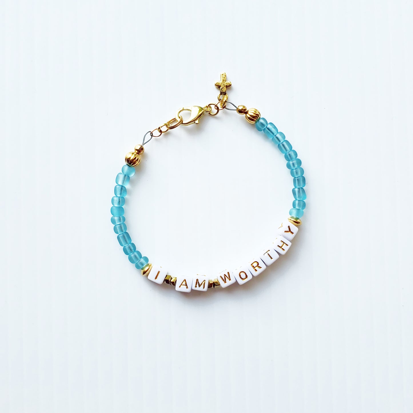 Aqua and gold single strand stackable Word bracelet