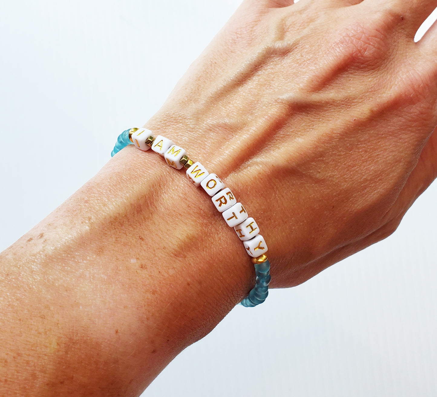 Aqua and gold single strand stackable Word bracelet