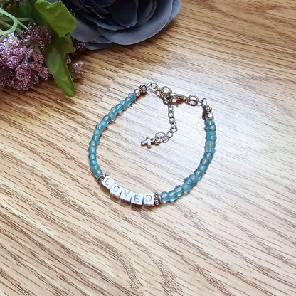 Aqua and silver single strand stackable Word bracelet